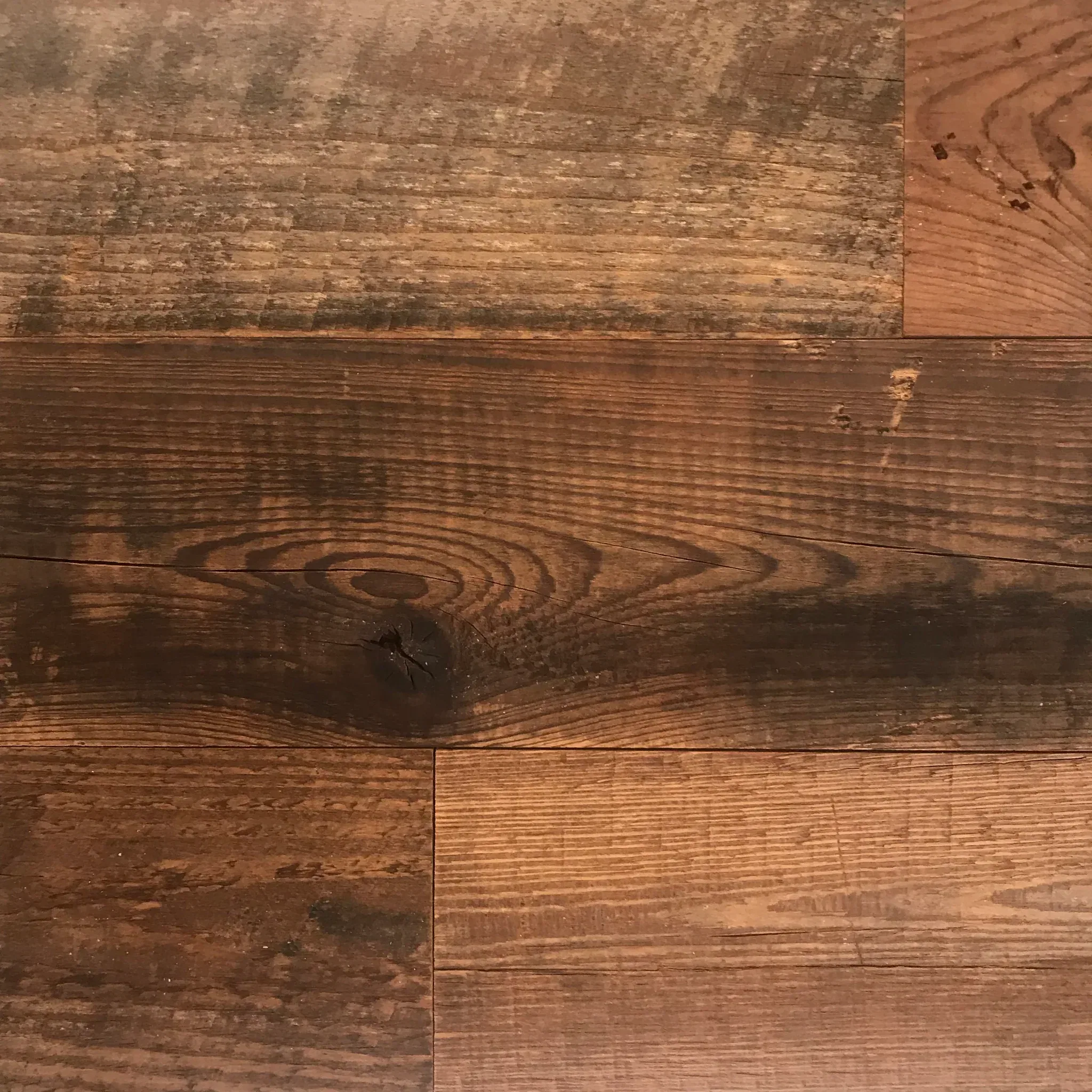 Close-up of the Wall & Ceiling Accent Plank displaying a natural wood grain, arranged in a staggered pattern with various brown shades and subtle surface imperfections.