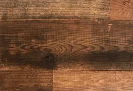 Close-up of the Wall & Ceiling Accent Plank displaying a natural wood grain, arranged in a staggered pattern with various brown shades and subtle surface imperfections.